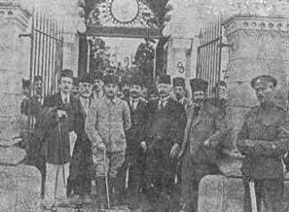 Gallows humor from the British; the Malta detainees pose in front of the Malta cemetery